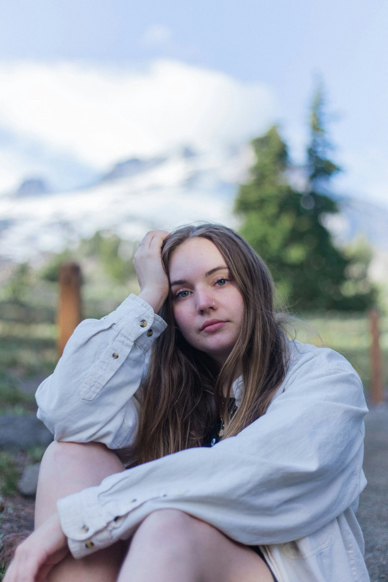 girl sitting on ground with long hair looking over her shoulder