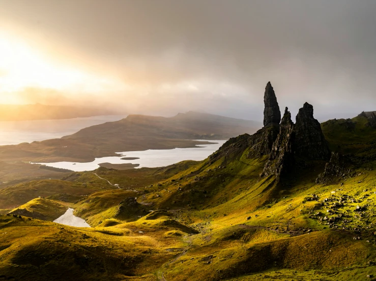 a very large mountain with a large body of water and mountains in the distance