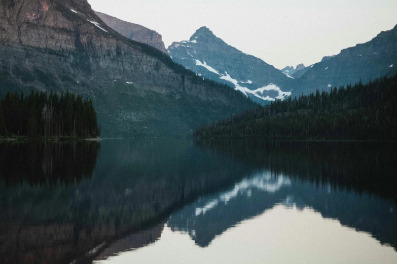 the mountains are very high and the water is still calm