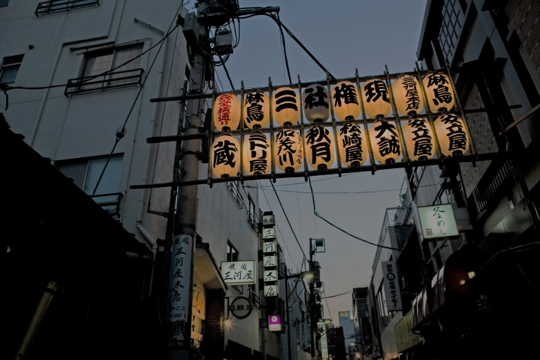 signs above city alley on telephone wires in a town