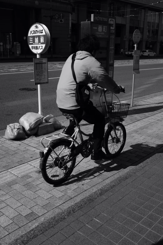 a person on a bicycle riding down the street