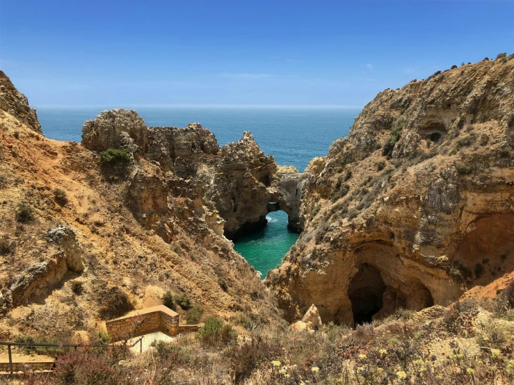 a cave overlooks the ocean and rocks by itself