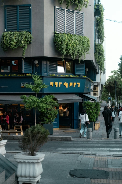 pedestrians cross the street outside of an establishment