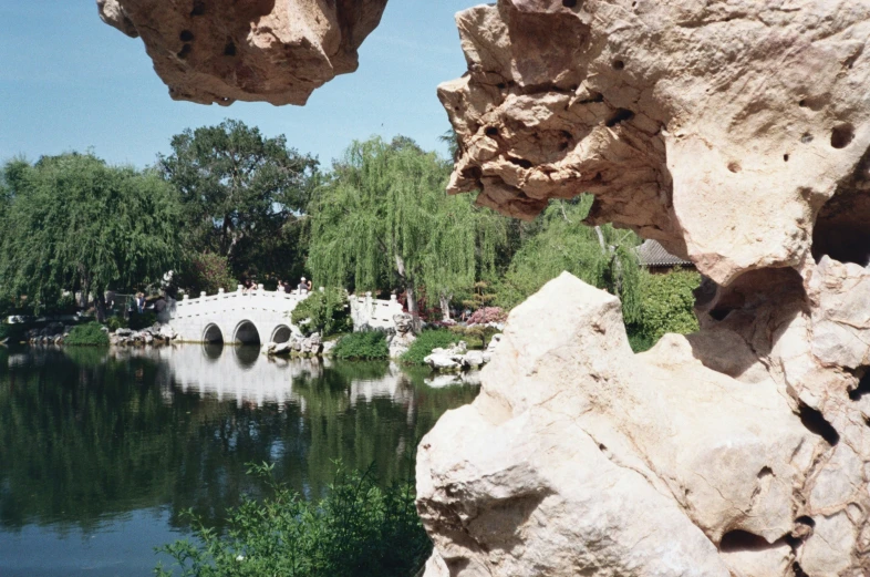 view of a bridge from inside some rocks