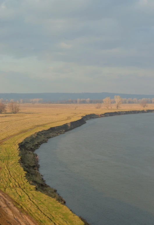 a body of water near an area with a road in front