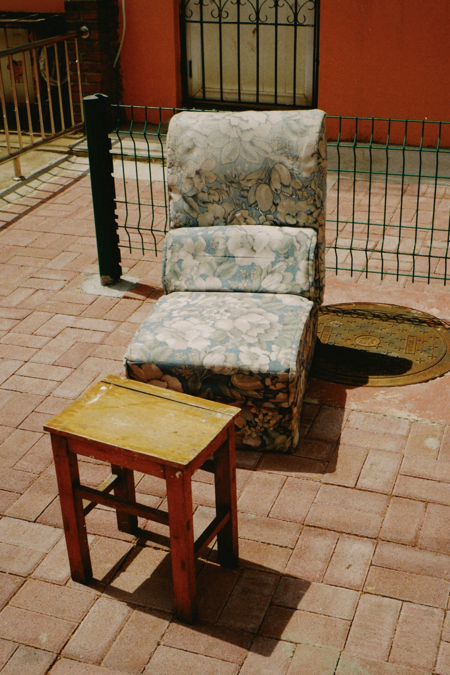 a chair sitting on top of a wooden table next to a foot stool