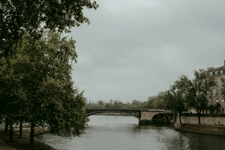 a bridge crossing over water near a large building