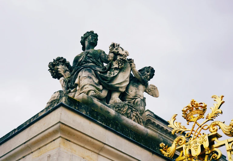 a sculpture is on top of a tall building