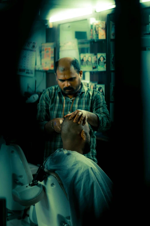 a barber is combing his client's hair in the barber shop