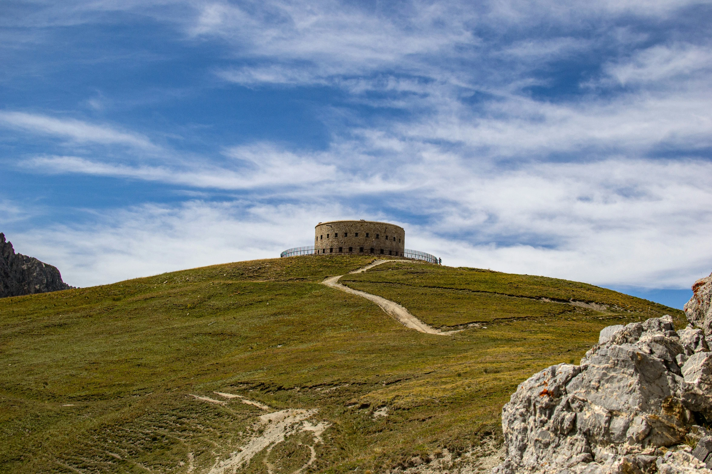 a view of an old tower on the top of a hill