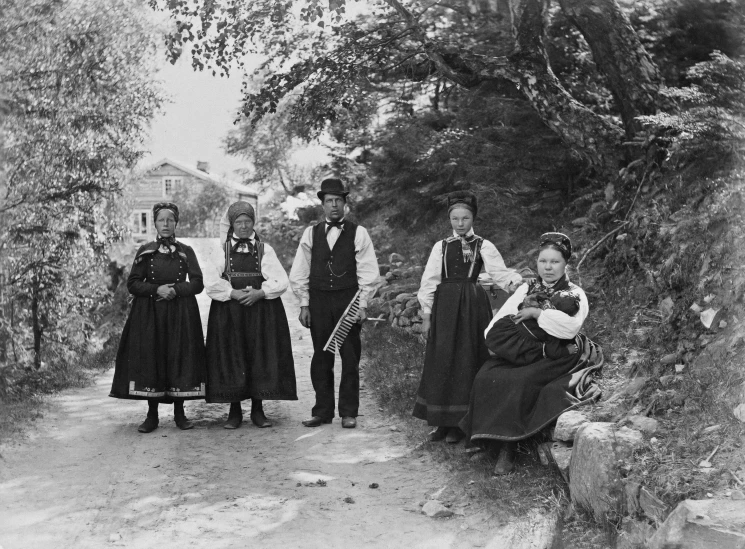 a group of people with long dresses standing together