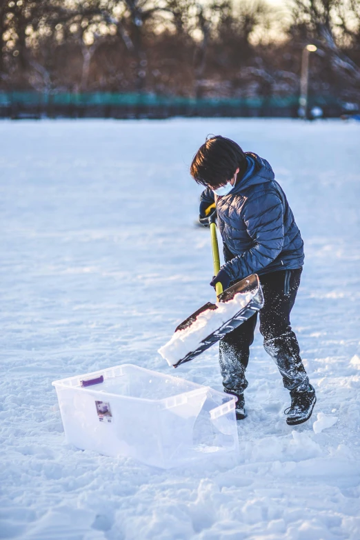 a  is digging into a snow box