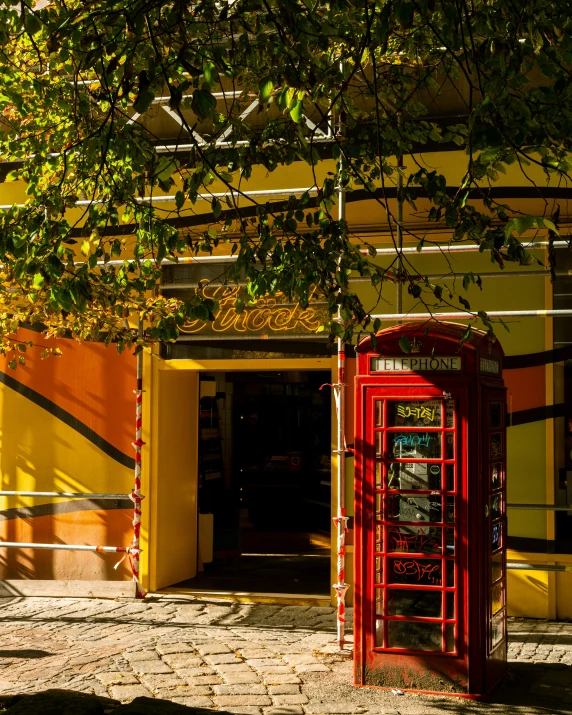 an open door to a building with a red phone booth