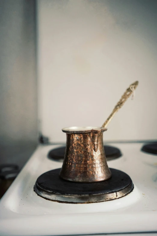 a cooking pot sitting on top of a stove