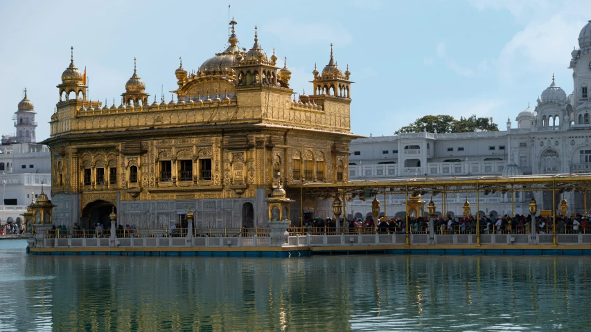 a large gold ornately painted building on top of water