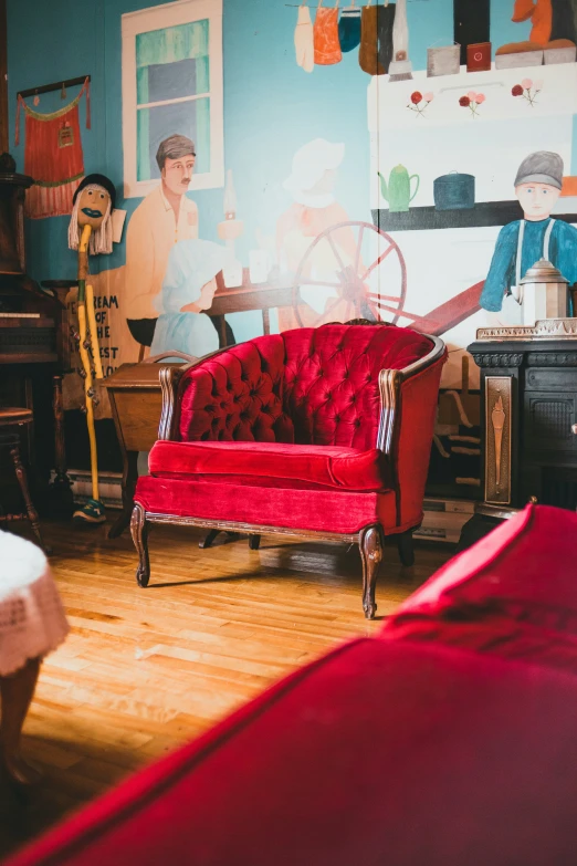 a red couch sits in the middle of a room