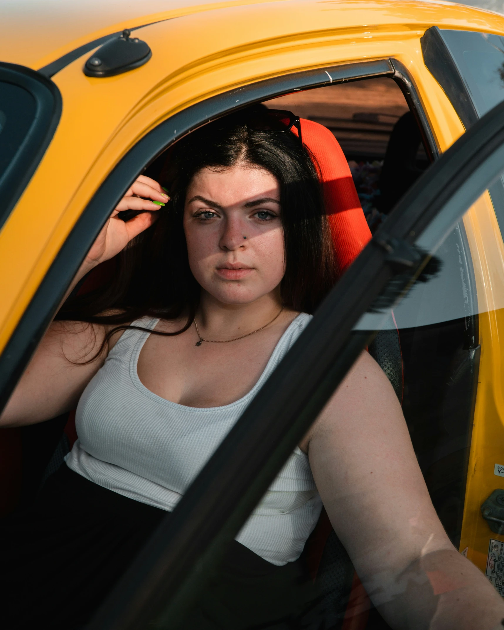 a woman that is sitting in the back of a car