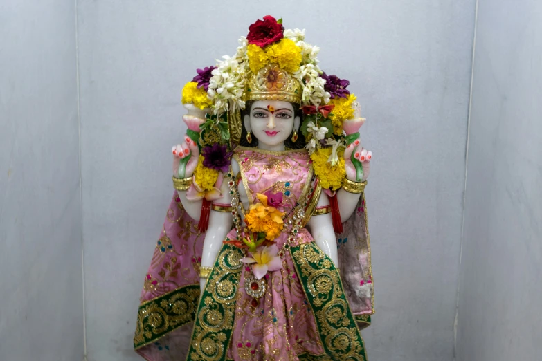 the statue is displayed and decorated with flowers