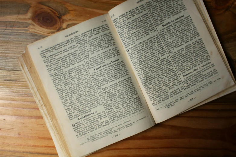 an open book with writing on it sitting on top of a table