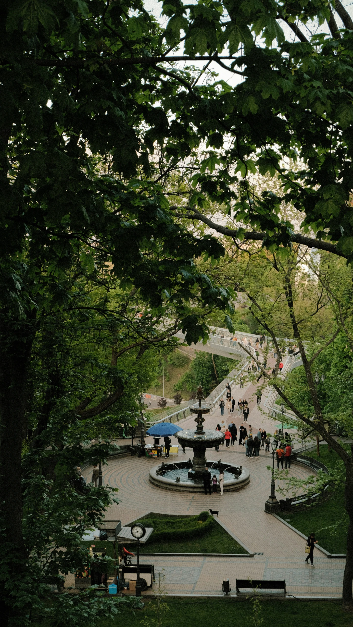 an outdoor patio area with fountain and stairs in distance