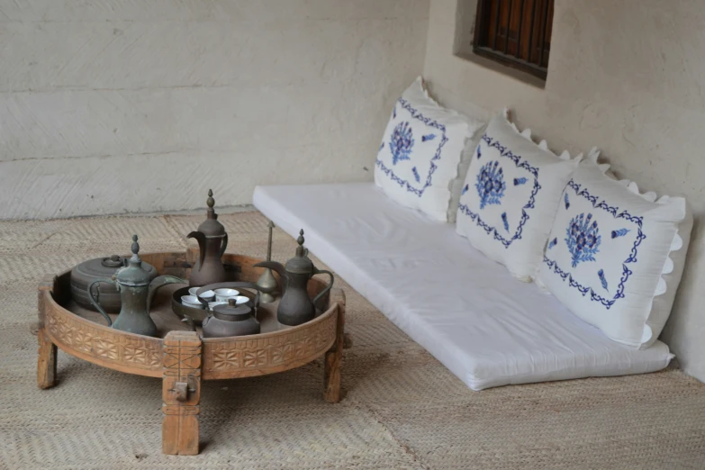 a small table that has three vases on top of it