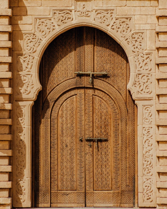 a very ornate door is set in a building