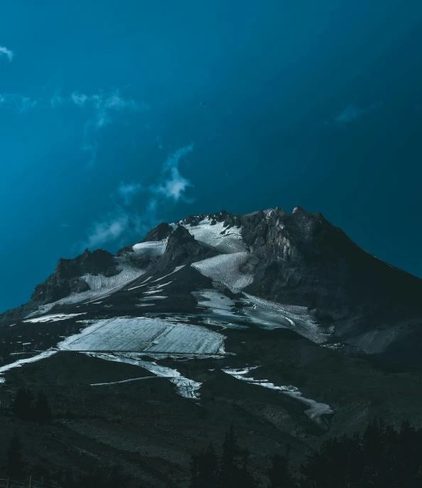 an airplane flies over a snowy mountain peak