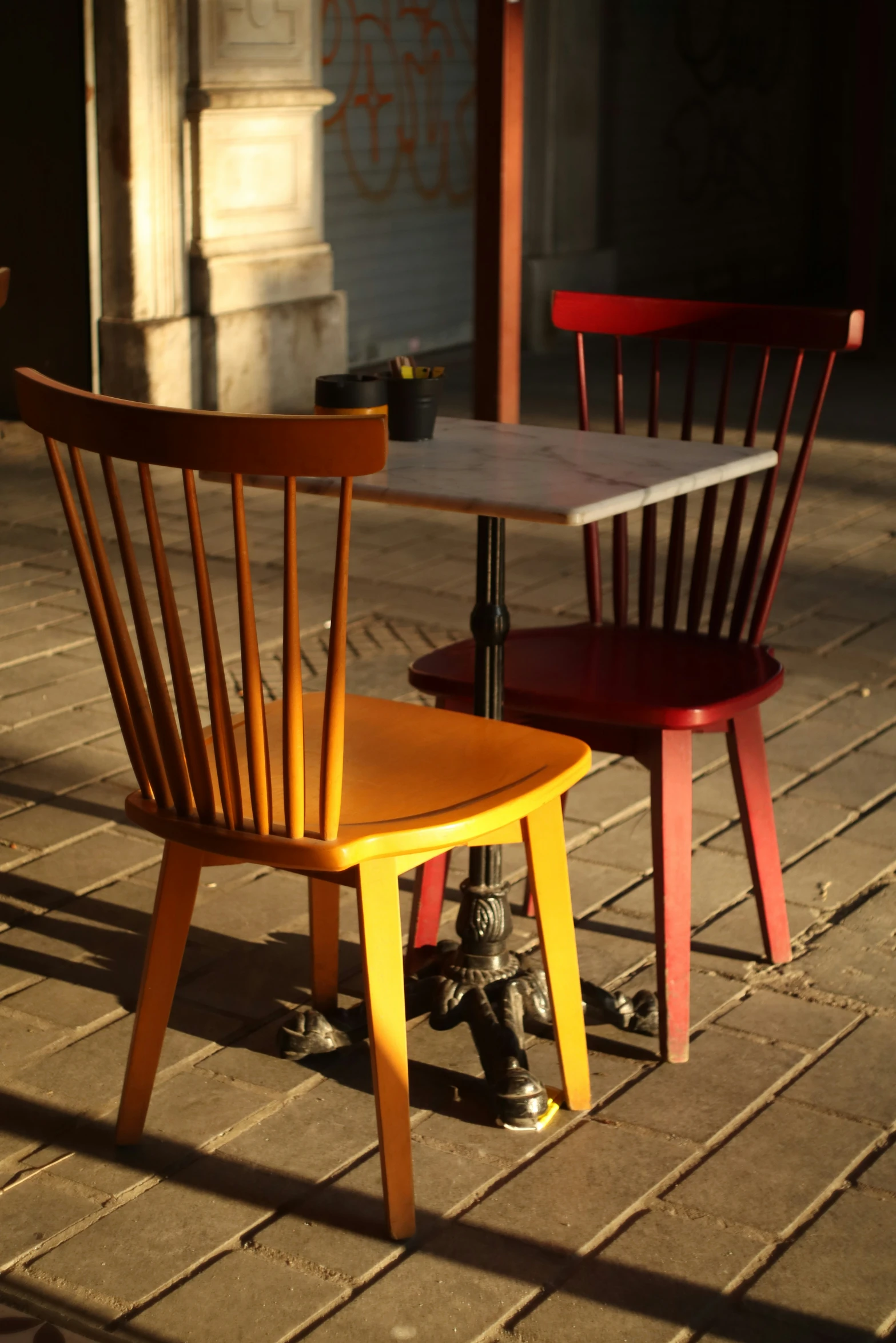 a couple of wooden chairs sitting next to each other