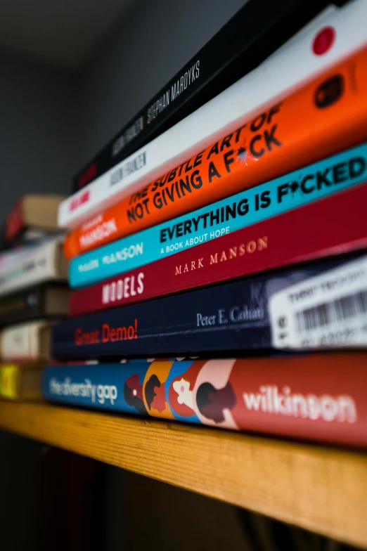 some books are sitting on a shelf together