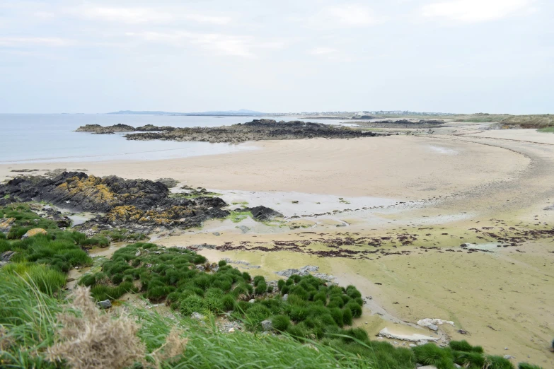 a body of water sitting next to a sandy shore