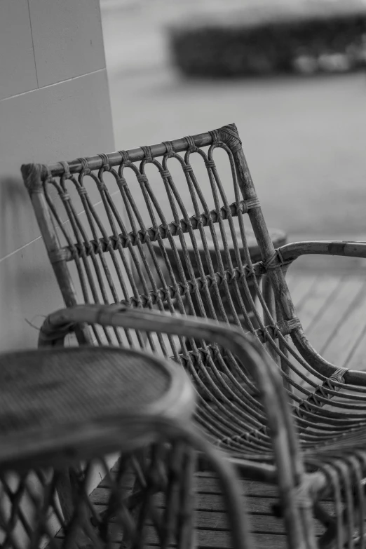 the wicker furniture is set outside on the wooden patio