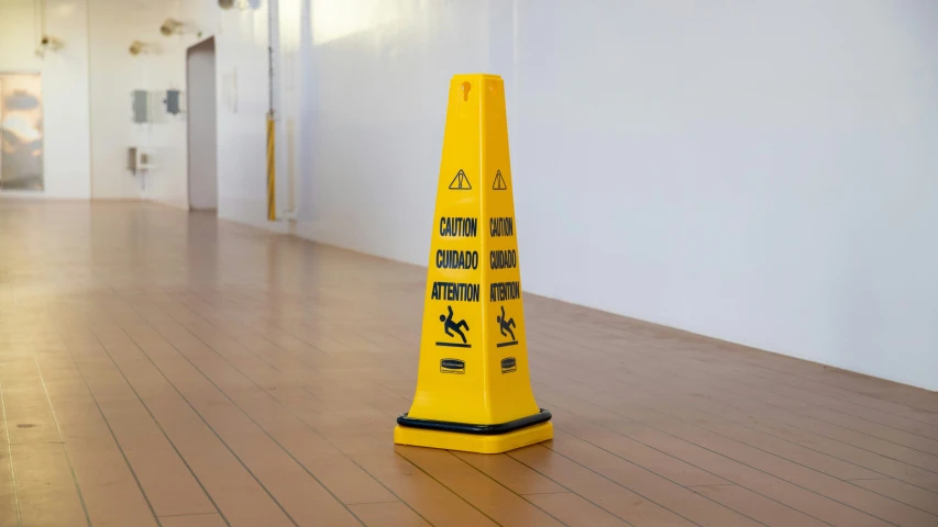 a caution cone on the floor of a hall