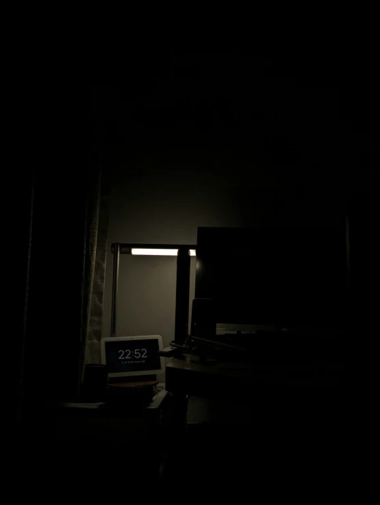a view of a bed sitting in a room at night