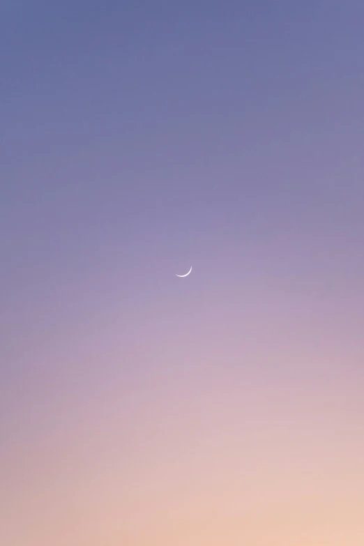 a lone white moon visible in the distance