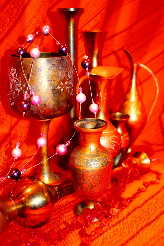 an arrangement of oriental vases and ornaments on a table