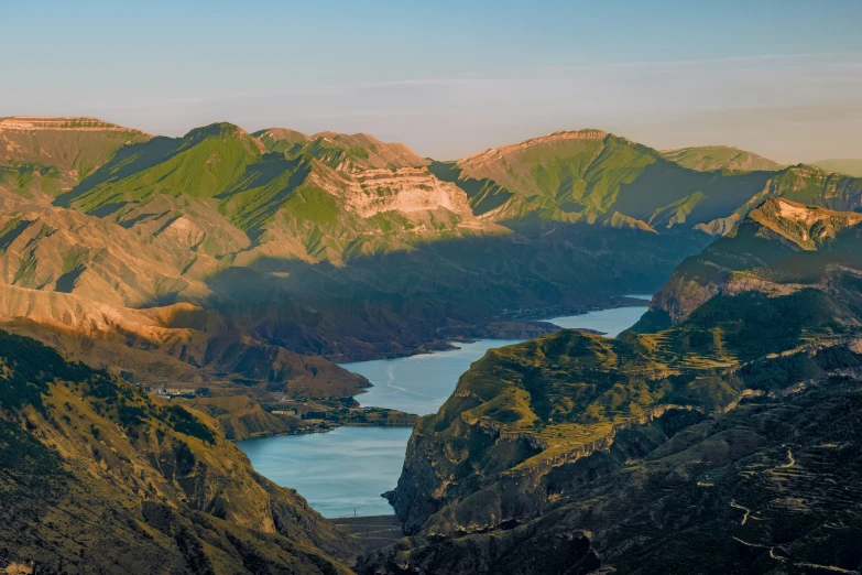 the sun shines on some steep mountains