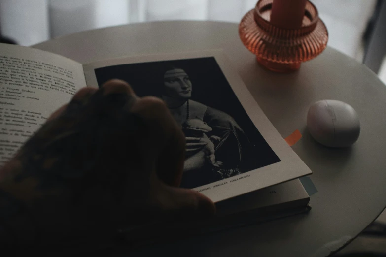 a person is reading the book with their left hand