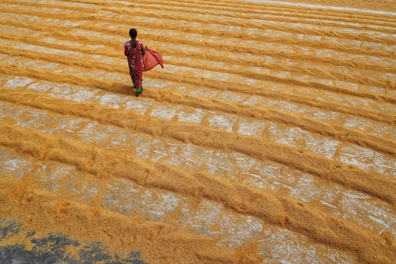 a woman walks on a field in the daytime