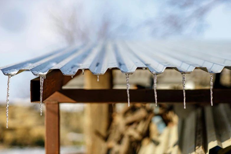 some icicles hanging from a large metal roof