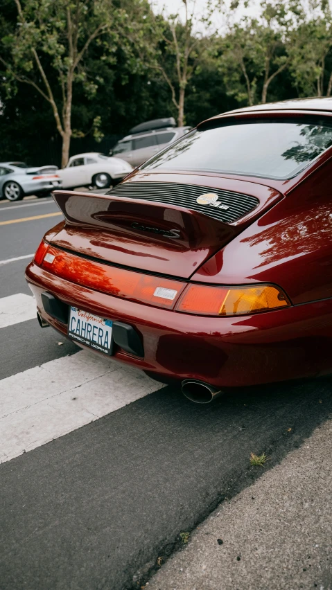 a red sports car is parked in a parking lot