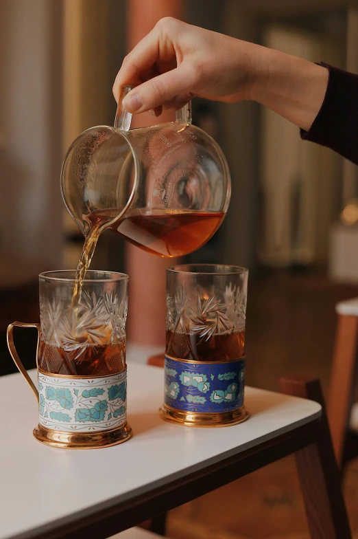 the coffee was poured into the mug on the table