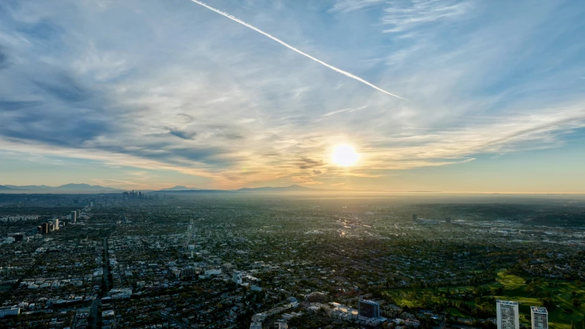 a sun shines on top of a large city