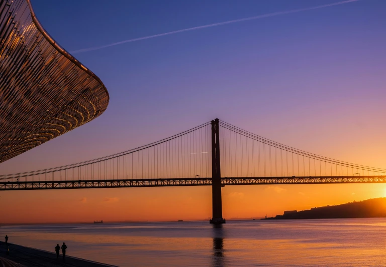 the golden gate bridge is silhouetted at sunset