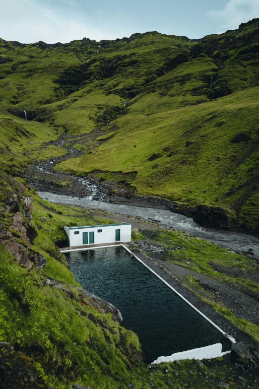 there is a small house on top of the hill