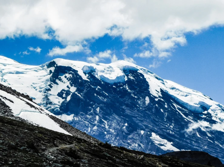 a mountain side in the mountains has snow on it