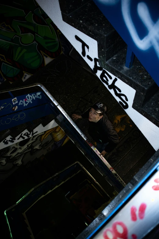 this po shows a skateboarder standing in the shadows