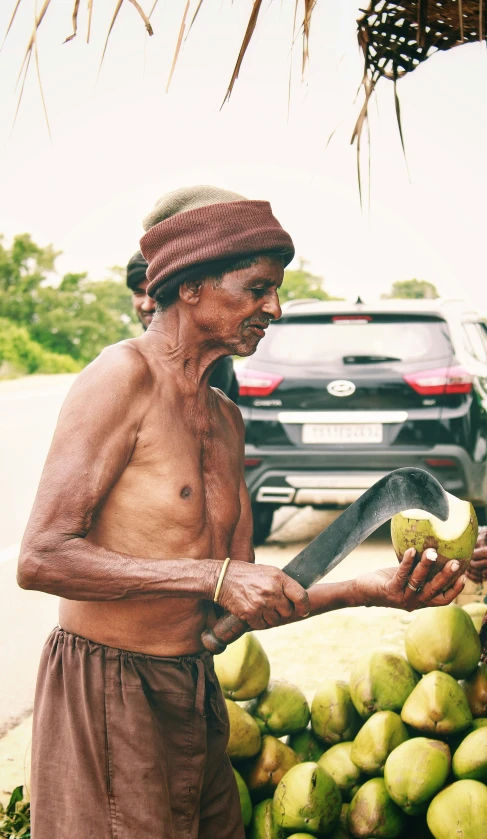 there is a man that is holding a large fruit