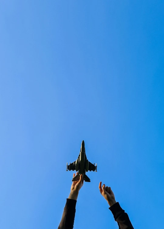 a man and a woman hold hands toward a jet