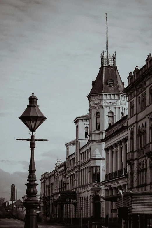 a very old street light on the side of a building