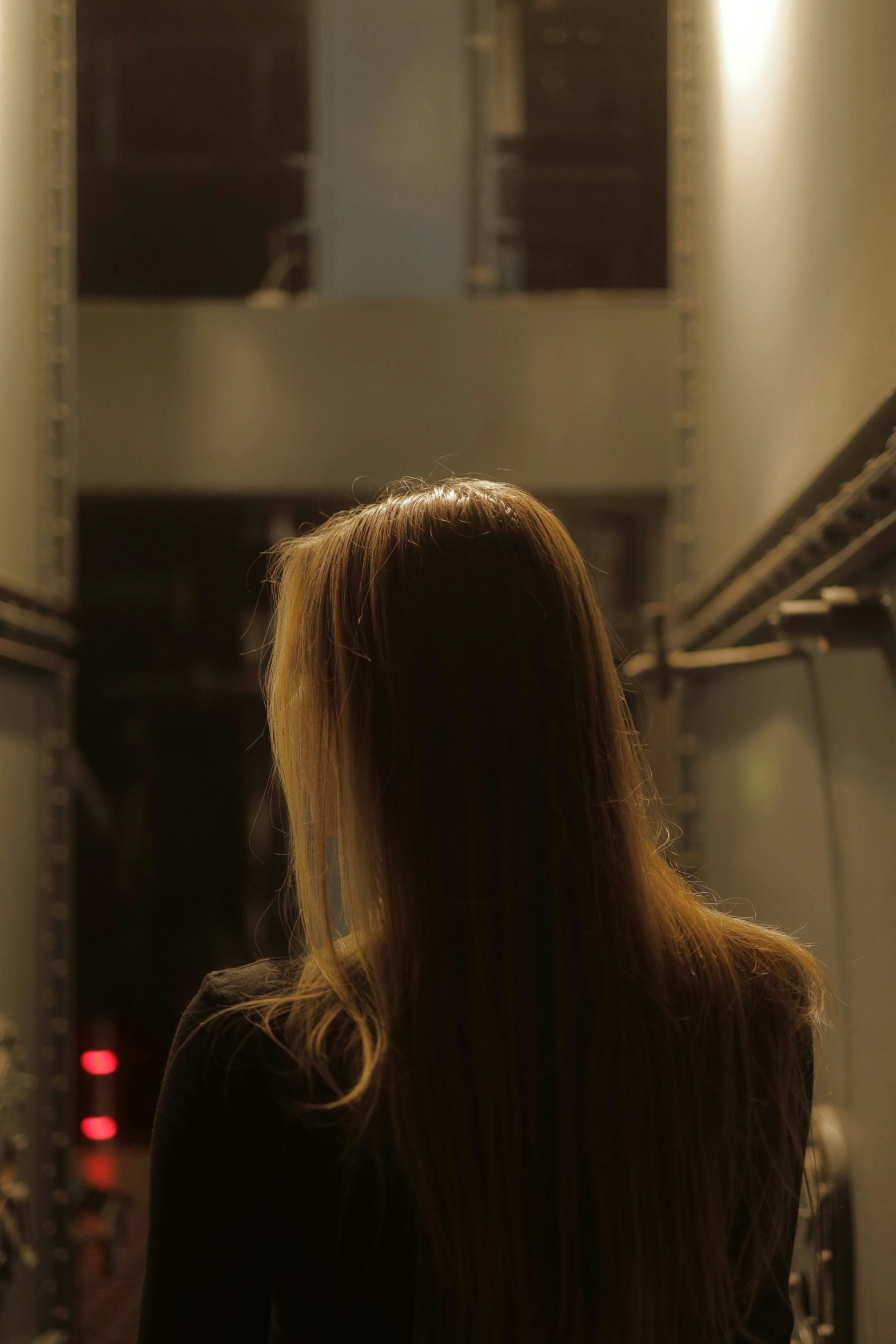 a woman standing in front of a mirror